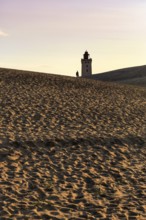 Rubjerg Knude lighthouse, walkers on hiking dune, evening mood in summer, Løkken, Lokken,