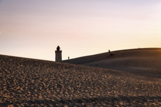 Rubjerg Knude lighthouse, walkers on hiking dune, evening mood in summer, Løkken, Lokken,