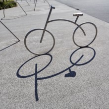Bicycle, stainless steel bicycle rack, casts shade, bicycle parking, Aalborg, Jutland, Denmark
