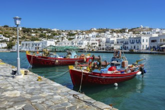 Mykonos, Cyclades, Greece - Colourful fishing boats are moored on the quay in the old port of