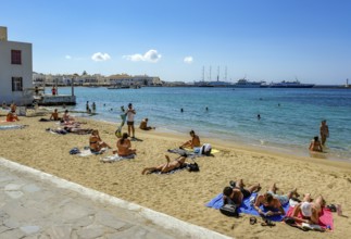 Mykonos, Cyclades, Greece - Tourists and locals like to bathe at the small town beach Paralia