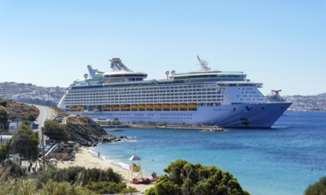 Mykonos, Cyclades, Greece - Voyager of the Seas cruise ship is located in Mykonos Harbour Bay. In