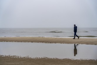 East beach of the East Frisian island of Spiekeroog, beach walk, man alone on the beach, at low