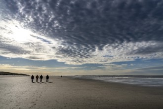 Walkers on the Wadden Sea near the East Frisian island of Spiekeroog, west of the North Sea island,