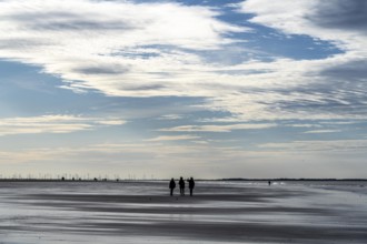 Walkers on the Wadden Sea near the East Frisian island of Spiekeroog, west of the North Sea island,