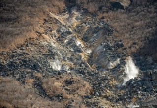Steaming fumaroles in the Owakudani geothermal area at Komagatake volcano, Hakone, Japan