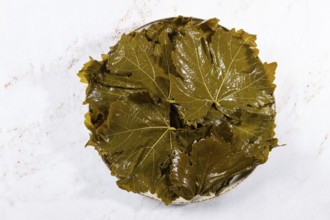 Canned grape leaves, for cooking dolma, on a plate