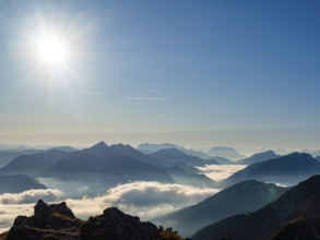 Blue-colored silhouette of mountains, fog in the valley, Wilder Kaiser and Chiemgau Alps, Upper