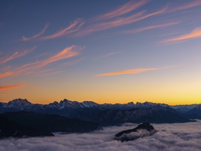 Red-colored plume clouds over the Berchtesgaden Alps at dusk, fog in the valley, Hochstaufen,