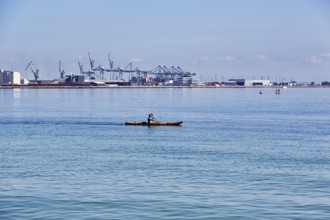 Kayaker, view of port facilities, container port, Aarhus, Jutland, Denmark
