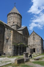 Old church with a distinctive tower and massive stone walls, divided into various building