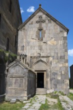 Historic church entrance with stone decorations and crosses, Tatev monastery, Tatev, Armenian