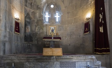 Choir with cross windows and candlelight, spiritual atmosphere, Tatev monastery, Armenian Apostolic