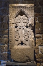 Elaborated stone relief with cross and ornaments on a wall, Khachkar, Armenian Cross Stone, Tatev