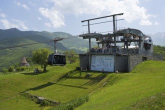 Cable car station on a green hill with views of the surrounding mountain landscapes, Tatev cable