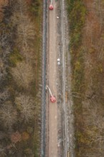 Aerial view of a construction site in the forest with machinery and lift on a slope, construction