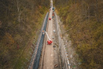 Aerial view of construction on a path between autumn trees, construction of the Hermann Hesse