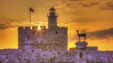 Agios Nikolaos fortress, castle with lighthouse and statue in rising sun and golden sky, UNESCO