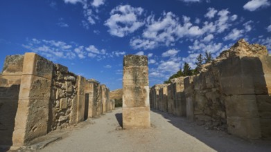 Old ruins with high stone walls under blue sky with scattered clouds, UNESCO World Heritage Site,