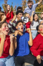 Diverse group of young sports fans cheering passionately in stadium stands, face paint and
