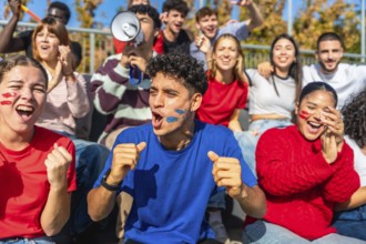 Multiracial young people celebrating and cheering passionately in a stadium, showing excitement and