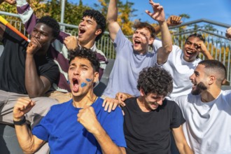 Diverse group of young men with painted faces and horns celebrating loudly, showing excitement and