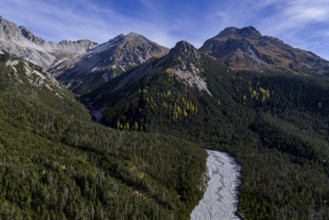 Mountain landscape, wild, untouched, coniferous forest, sunny, riverbed, autumn, aerial view, Val
