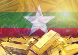 Gold bars on Myanmar flag in background. Gold bars stacked on Burmese flag. Concept of Myanmar gold