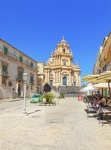 Tourists sitting in local restaurants in the main square, Ragusa Ibla, Ragusa province, Sicily,