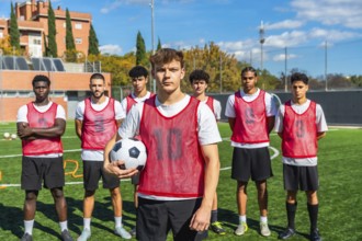 Coach, players and athletes preparing for soccer training, practicing on a green turf field during