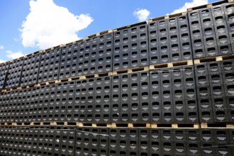 Stacked black beer crates from the Kulmbacher Group, a beverage manufacturer that includes