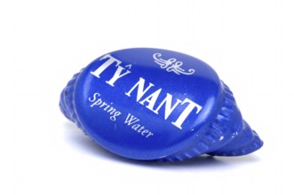 Screw cap of a water bottle, mineral water, Ty Nant, in blue designer bottle, water from Wales, is