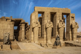2nd courtyard with Osiris statues, head of a statue of Ramesses II in front of it, Ramesses II