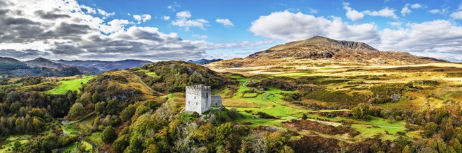Autumn colours over Castell Dolwyddelan and Eryri Mountains from a drone, Snowdonia, Conwy County