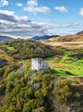 Autumn colours over Castell Dolwyddelan and Eryri Mountains from a drone, Snowdonia, Conwy County