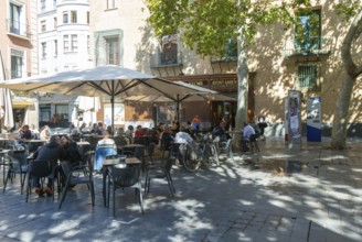People sitting at tables and chairs in courtyard, Plaza de San Filipe, Zaragoza, Aragon, Spain