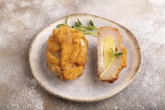 Chicken schnitzel on blue plate with microgreen on brown concrete. Diet, healthy eating. side view,