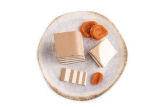 Cocoa and milk jelly with dried apricots isolated on white background, top view, flat lay,