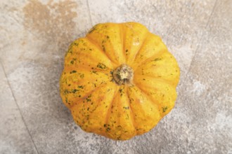 Orange Pumpkin on brown concrete background. Top view, close up, flat lay. healthy food, vegetable,
