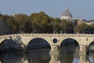 Bridge over the river Tiber with the dome of St. Peter's Basilica in the Vatican city in the
