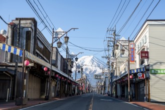 Road through the Japanese town of Fujiyoshida, behind the volcano Mt. Fuji, Yamanashi Prefecture,