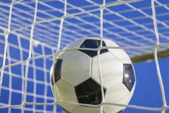 Soccer symbol: close-up of a soccer ball under floodlights