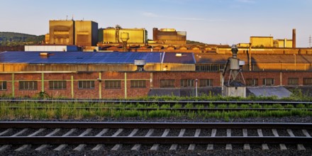 Deutsche Edelstahlwerke with train tracks at sunrise, central railway station, Witten, Ruhr region,