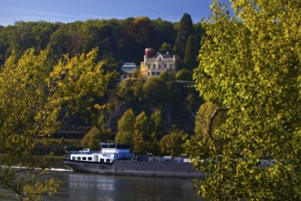 Marienfels Castle with cargo ship on the Rhine River, former residence of entertainer Thomas