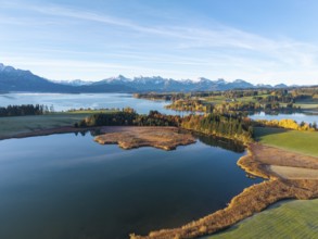 Quiet lake with autumnal shore and mountain panorama in the background, Illasbergsee, Forggensee,