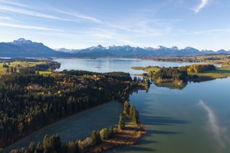Autumn mountain landscape with a quiet lake and forests under blue sky, Illasbergsee, Forggensee,