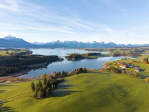 Panoramic view of meadows, a lake and mountain peaks in the distance, Illasbergsee, Forggensee,