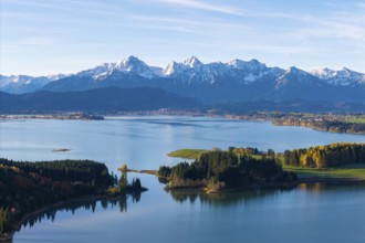 Clear mountain lake with forests on islands in front of a mountain range, Illasbergsee, Forggensee,