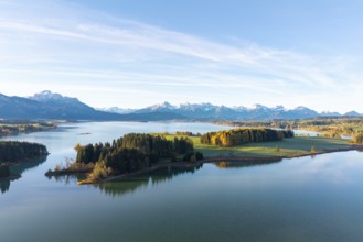Landscape with large lake surrounded by forests and alpine landscape under blue sky, Illasbergsee,