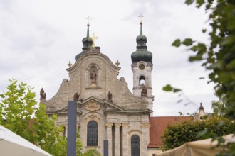 Baroque church with distinctive towers and sculptures against a cloudy sky, ZFP Zwiefalten,